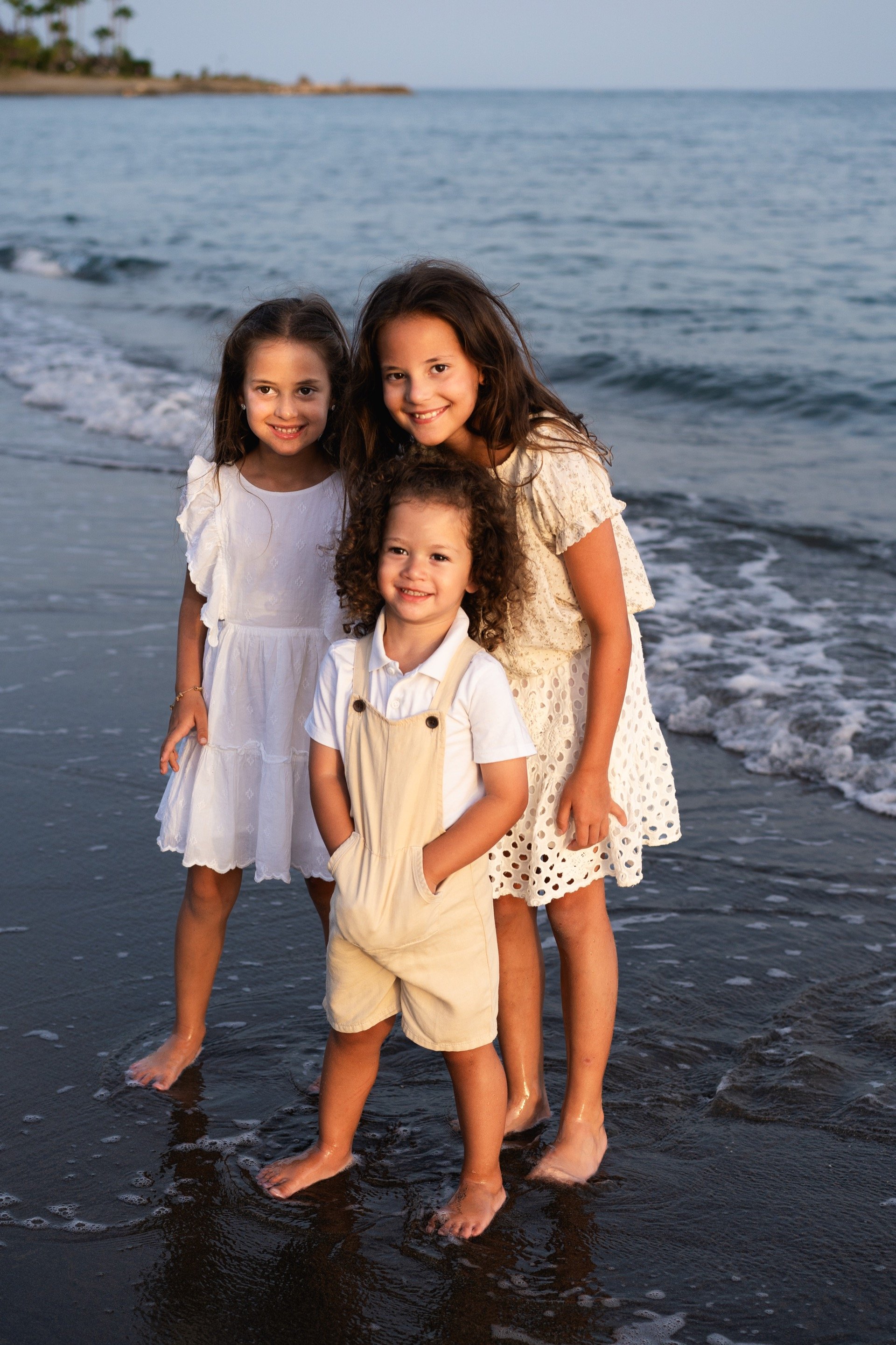 Family walking along Marbella coastline